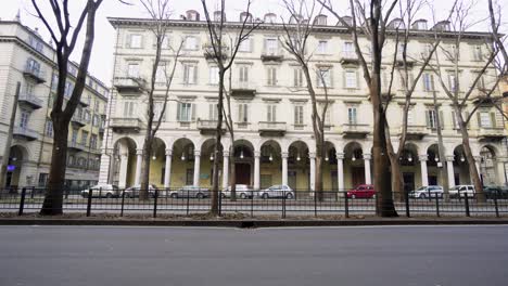 Building-facade-in-Turin-and-ambulance-passing-in-foreground