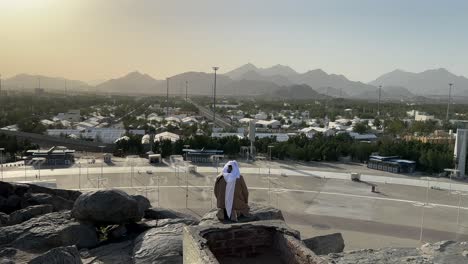 A-man-praying-at-Jabal-al-Rahmah,-is-a-significant-site-located-in-the-plain-of-Arafat,-near-Mecca-in-Saudi-Arabia