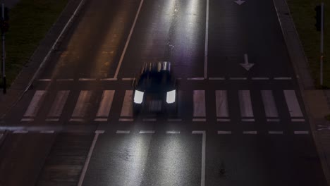 Evening-busy-three-lane-road-full-of-cars-with-pedestrians-crossing-the-road