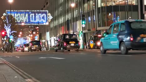 Hustle-and-bustle-of-heavy-smooth-traffic-flow-downtown-London-at-night