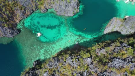 Tilt-Up-Aerial-View-of-Majestic-Coastline-of-Coron-Island,-Philippines