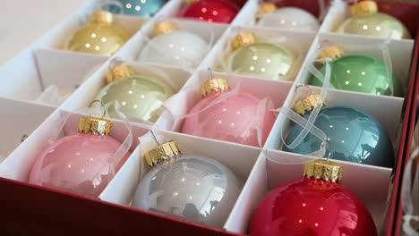 Close-up-view-of-vibrant-Christmas-ornaments-arranged-in-a-box