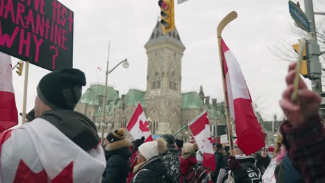 People-Demonstrating-Against-Covid-19-Vaccine-Rules-Holding-Flags-During-Freedom-Convoy-2022-In-Ottawa,-Canada