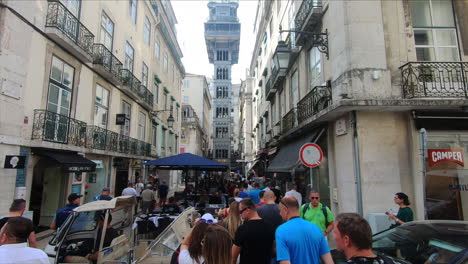 People-walking-towards-the-Santa-Justa-Elevator,-Elevador-de-Santa-Justa-in-Lisbon,-Portugal