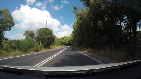 Tourists-bus-and-landscape-of-Crete-island-while-driving,-POV