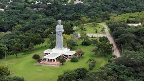 Aerial-image-approaching-the-"Cristo-Penitente"-in-the-city-of-La-Caldera,-Salta,-Argentina