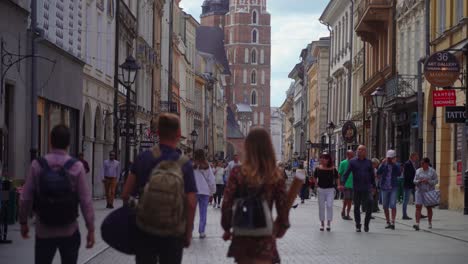 Video-of-people-walking-in-the-Floriańska-Street-with-numerous-shop,-cafe-and-restaurant-and-other-establishments-in-Kraków,-Poland