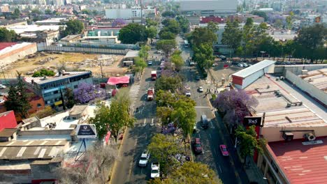 Dolly-out-flyover-following-a-pilgrimage-on-a-sunny-day-in-Mexico-city,-slow-motion