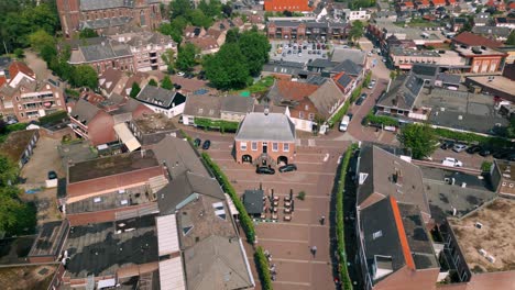 Aerial-view-of-Budel's-Markt-street,-showcasing-De-Schout-and-the-charming-townscape-of-Brabant's-Cranendonck-area