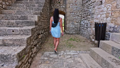 Young,-attractive,-Caucasian-woman-at-a-medieval-castle---walking-in-slow-motion