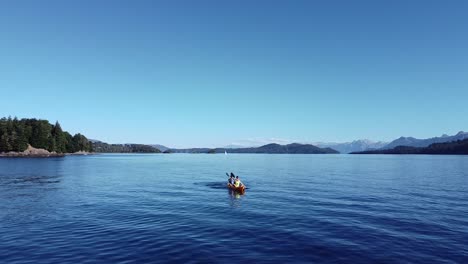 Aerial-static-shot-of-people-doing-Kayaking-in-the-lake-of-Nahuel-Huapi-in-Patagonia-Argentina