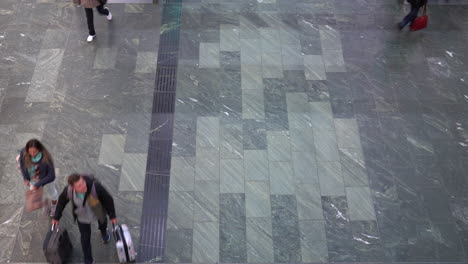 walking-people-from-above-on-a-marble-floor