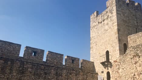 Scenic-closeup-of-medieval-stone-mortar-defensive-medieval-castle-watch-tower-with-battlements-in-4k