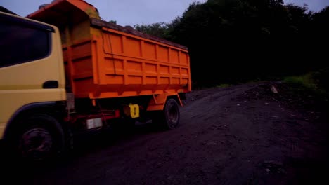 Colorful-Truck-and-motorbike-driving-on-rural-road-during-dusk-in-near-of-Merapi-Volcano,close-up