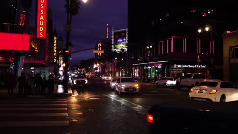 Busy-Night-Traffic-on-Hollywood-Boulevard,-Cars,-Colorful-Lights-and-Buildings,-Los-Angeles-CA-USA