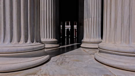 POV-shot-while-walking-into-Zappeion-Hall-with-pillars-on-both-sides-in-Greece-on-a-sunny-day