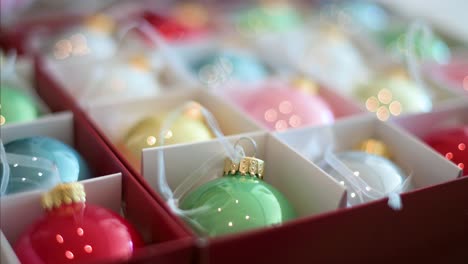 Focused-shot-of-shiny-Christmas-decorations-in-a-storage-box