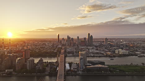 NYC-New-York-Aerial-v367-reverse-flyover-Queensboro-bridge-through-Manhattan-capturing-Lenox-Hill,-Roosevelt-Island-and-Queens-cityscape-across-East-river---Shot-with-Mavic-3-Pro-Cine---September-2023