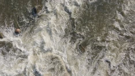 Powerful-waterfall-with-turbulent-waters-rushing-over-rocks-in-Owen-Sound,-Canada