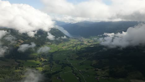 Sideways-Drone-Shot-of-Vikøyri-Enclosed-with-Beautiful-Clouds-in-Vik-i-Sogn,-Norway