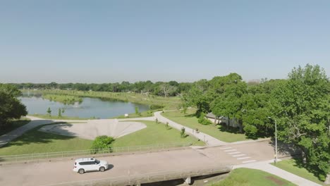 An-aerial-view-of-an-adult-male-cycling-through-Exploration-Green-Phase-4-on-a-clear,-sunny-morning-in-Clear-Lake,-Houston,-Texas