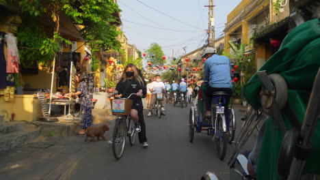 A-POV-shot-of-a-tourist-riding-onboard-a-cyclo-rental-or-also-called-a-three-wheel-bicycle-taxi-in-Hoi-An,-Vietnam