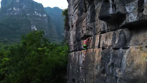 Man-Rock-Climbing-Mountain-in-Yangshuo-Guilin,-China---Aerial-Drone-View