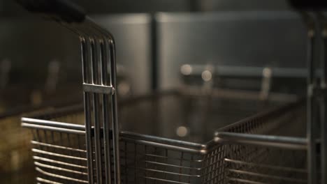 Hands-with-black-gloves-puts-bread-in-fryer