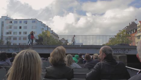 Tourist-boat-trip-on-the-canals-of-the-city-with-cloudy-sky