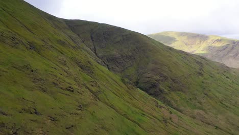 Aerial-sweep-along-lush-valley-in-the-highlands-of-Scotland-on-a-cloudy-day