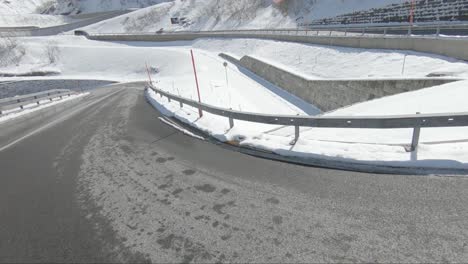 Red-Ferrari-slowing-down-to-take-a-corner-on-a-mountain-road