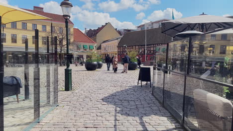 Entering-Lilla-Torg---Little-Square-in-Malmo,-old-style-houses,-cobble-stones,-and-colourful-buildings