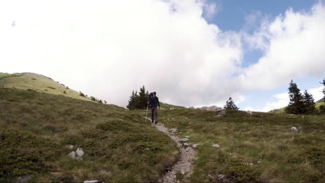 A-hiker-walking-alone-along-the-trail-in-the-mountains-on-a-sunny-day-in-Croatia