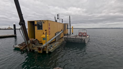 A-dredging-barge-sits-at-Stony-Point-boat-ramp-on-a-cloudy-day