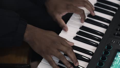 Close-up-of-hands-playing-piano-keys,-showcasing-musical-performance-detail