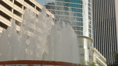 Reveal-shot-that-starts-at-water-fountain-then-reveal-building-in-downtown-Houston,-Texas