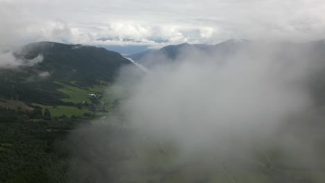 Aerial-Drone-Shot-Flying-through-a-Cloud-Revealing-Vikøyri-in-Vik-i-Sogn,-Norway