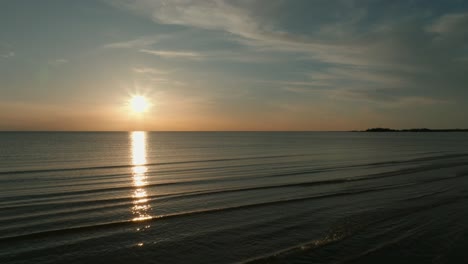 Sunset-over-Lake-Huron-with-calm-waves-and-golden-reflections-in-Canada