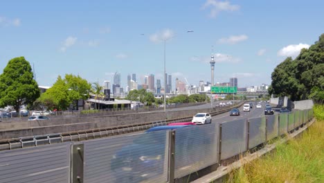 Los-Vehículos-Se-Mueven-A-Toda-Prisa,-La-Transitada-Autopista-De-Auckland,-Nueva-Zelanda,-Vista-De-Fondo-De-La-Ciudad