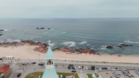 Church-tower-Igreja-Nosso-Senhor-dos-Navegantes-with-sea-view-in-Caxinas,-Vila-do-Conde,-Portugal