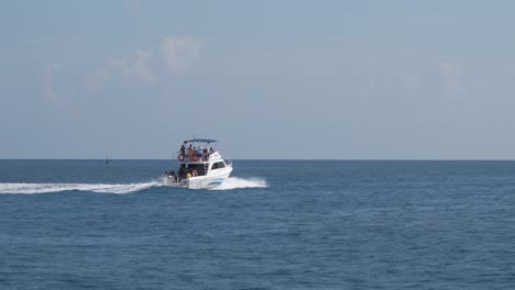 Luxury-yacht-in-Caribbean-sea-with-tourists-on-board,-tracking-shot