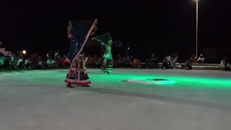 Traditional-folk-dancers-performing-Kalbelia-dance-at-a-fair-in-Jaisalmer-city-at-night