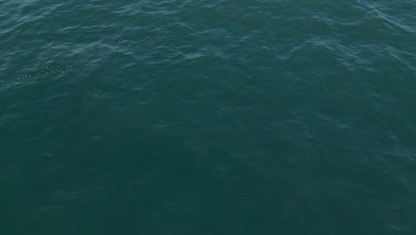 Deep-blue-ocean-waves-captured-from-above-with-light-reflections-on-the-surface