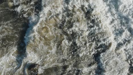 Rushing-water-cascades-down-the-waterfall-at-Owen-Sound,-Canada,-aerial-view