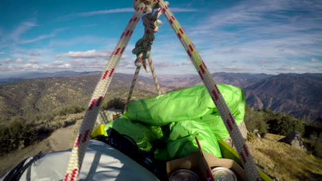 Basket-of-camping-supplies-being-pulled-up-a-pulley-to-the-top-of-a-fire-lookout-cabin