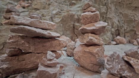 Small-piles-rock-formed-cairns-balance-in-Eyes-of-God-cave-Prohodna