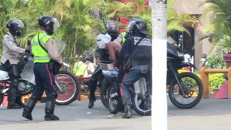 Zoom-in-on-demonstrator-beaten-during-a-daytime-protest-against-the-government-of-Nicolás-Maduro,-Caracas,-Venezuela