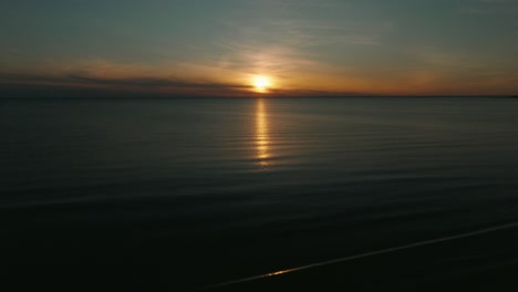 Sunset-over-Lake-Huron,-Canada-with-calm-waters-and-a-vibrant-sky