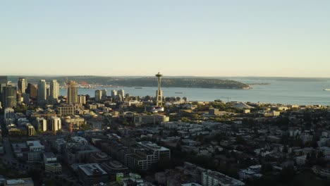 Last-light-of-day-shining-on-distant-Seattle-and-famous-Space-Needle,-aerial