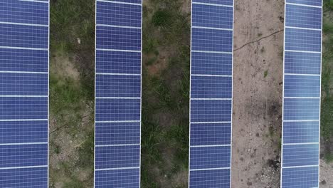 Zoom-In-aerial-shot-or-view-of-Solar-Power-Plant-arranged-in-a-pattern